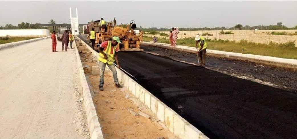 Crew laying asphalt beside a concrete kerb at ITUNU City, Ibeju-Lekki, Lagos